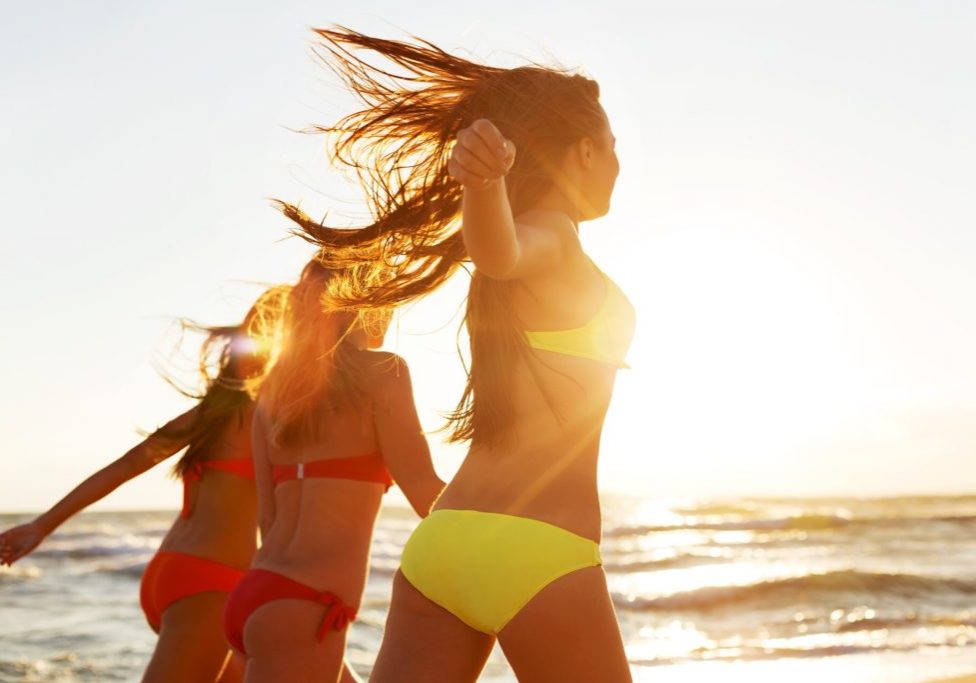 Girls running on Beach, having Party at golden Summer sunset background