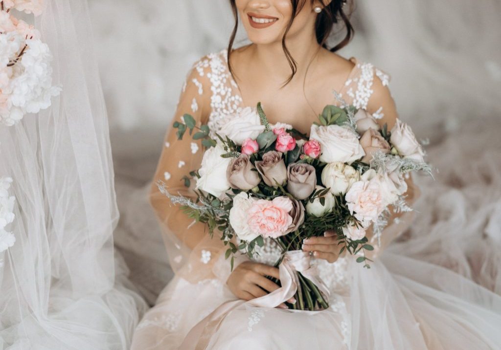 Luxury bride holding a big bouquet of flowers